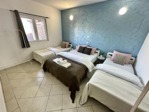 a room with three beds in a room at Apartmani Zaliv in Tivat