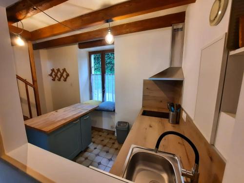 a small kitchen with a sink and a counter at Maison au calme en Chartreuse in Miribel-les-Échelles