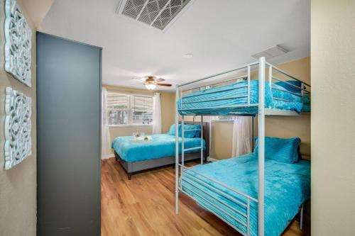 two bunk beds in a room with blue at Beautiful & Cozy Home on a Canal in Hudson, FL! in Hudson