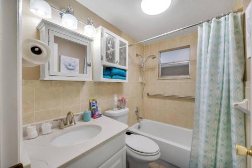 a bathroom with a sink and a toilet and a tub at Beautiful & Cozy Home on a Canal in Hudson, FL! in Hudson