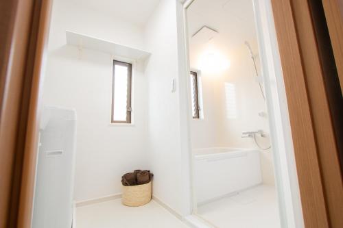 a white bathroom with a shower and a sink at Ikebukuro# Nakaitabashi 3DK room# 5 minutes walk from station in Tokyo