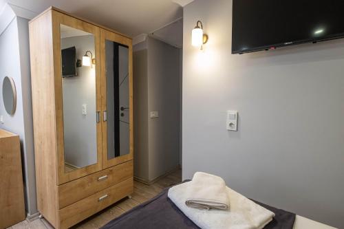 ein Badezimmer mit einem Spiegel und einem Holzschrank in der Unterkunft Family Istanbul Hotel in Istanbul