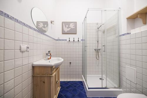 a bathroom with a shower and a sink and a toilet at Riviera Residence Apartments in Sopot