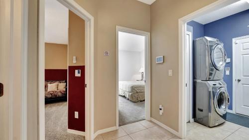 a room with a washing machine and a bedroom at Valrico's Hidden Gem A Stunning 3-Bedroom Oasis Awaits! in Valrico