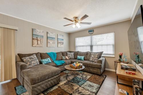 a living room with a couch and a ceiling fan at Exquisite Retreat with Heated Pool for 14 Guests, Pool Table Paradise! in Brandon