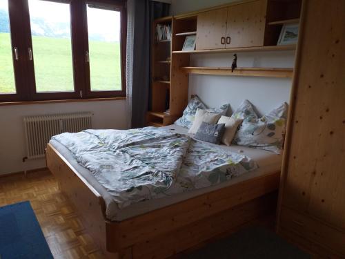 a bedroom with a large bed with pillows at "Gletscherblick" in Bad Aussee