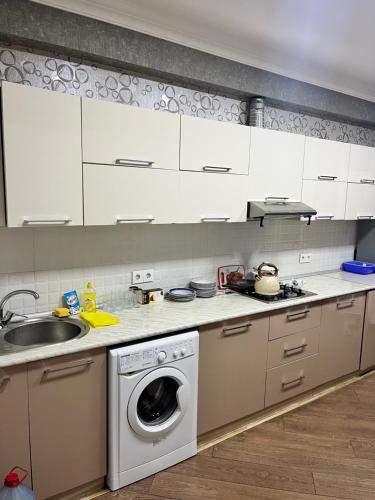 a kitchen with a washing machine and a sink at Apartment city in Baku