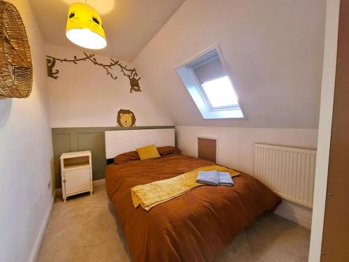 a bedroom with a large bed in a attic at Modern home close to amenities and transport links in Wymondham