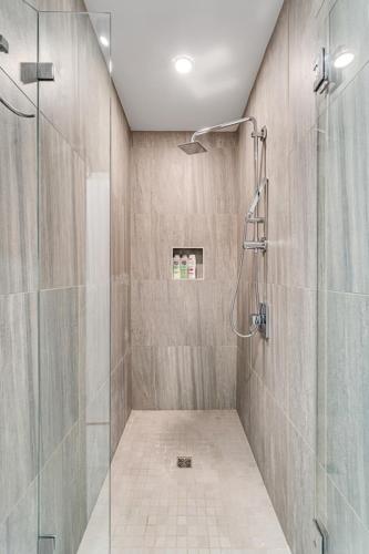 a bathroom with a shower with a glass door at The Founders Suite Residence in Philadelphia