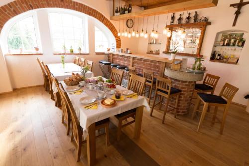 a dining room with a table and a bar at Bauernhof Zoller in Hartmannsdorf