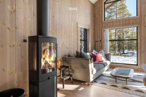 a living room with a fireplace and a couch at Trysilfjell hytteomrade 2124 by Vacation Trysil in Hovi