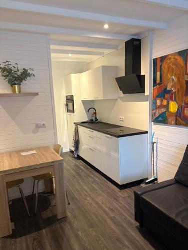 a small kitchen with a table and a counter top at Het molenhuisje in Winsum