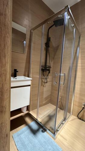 a shower in a bathroom with a sink at F3 2 Chambres Piscine Residence Point E in Dakar