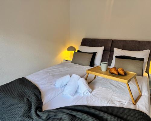a bedroom with a large bed with a table on it at Breathtaking Lake & Mountain View Apartment 2 in Niederried