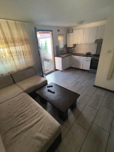 a living room with a couch and a coffee table at Casa Razu G2 in Craiova