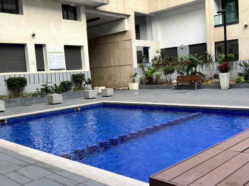 a large blue swimming pool in front of a building at Modern Comfort Studio, la corniche in Mohammedia