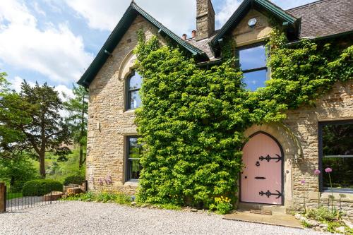 a brick house with a pink door at St Marks Stays in Sedbergh