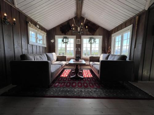 a living room with two couches and a rug at Welcoming Cabin With Fireplace & Modern Kitchen in Beitostøl