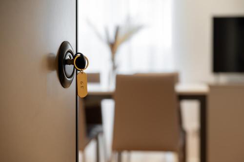 a door with a key on it with a table at Palazzo Machiavelli Trieste in Trieste