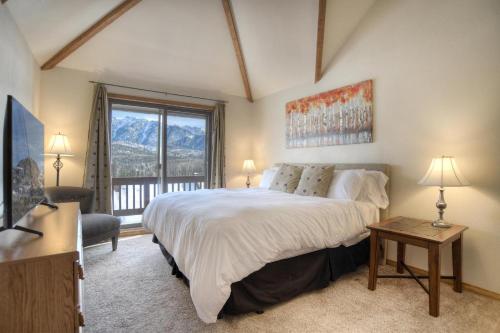 a bedroom with a large bed and a window at Cascade Village 59 in Durango Mountain Resort