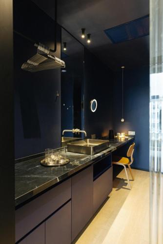 a black kitchen with a sink and a counter at Hotel Taro Santa Cruz in Santa Cruz de Tenerife