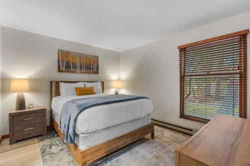 a bedroom with a bed and a window and a table at Bend Mt Bachelor Village Condo! in Bend