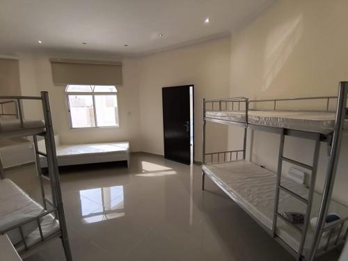 Una cama o camas en una habitación de KhavaQatar Hostel 2 بيت مشترك