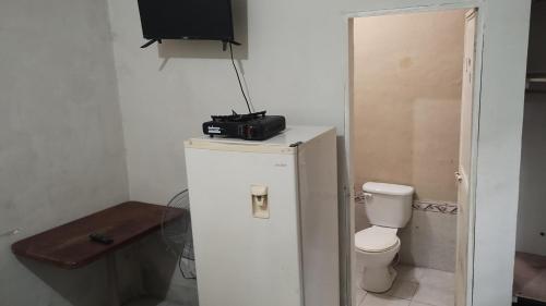 a camera on top of a refrigerator in a bathroom at Apartamentos Emanuel in San Benito