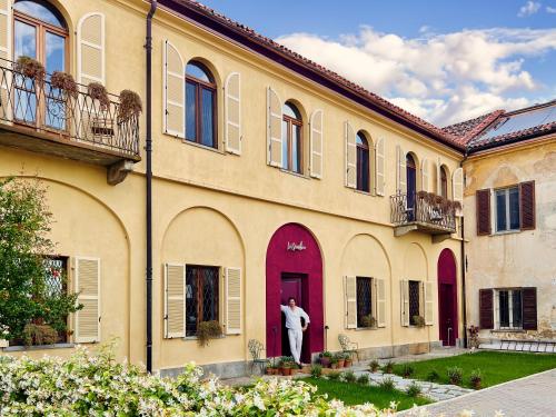a man standing in the doorway of a building at La Giardina Guest House in Chieri