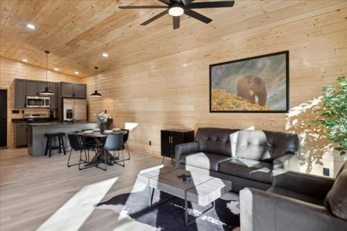 a living room with a couch and a table at Green & Black Bear Cabins By Beyond Expectations in Sevierville