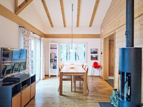 a kitchen with a wooden table and a stove at Holiday Home Chalet Ahornen by Interhome in Grindelwald