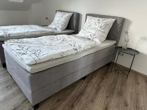 two beds sitting next to each other in a room at Ferienhaus Weimarer Land in Berlstedt