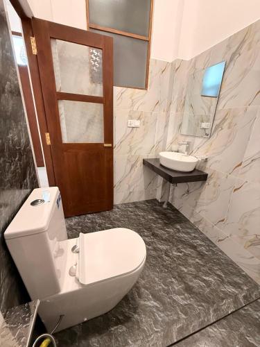 a bathroom with a toilet and a sink at Luxury Living Villas in Matara