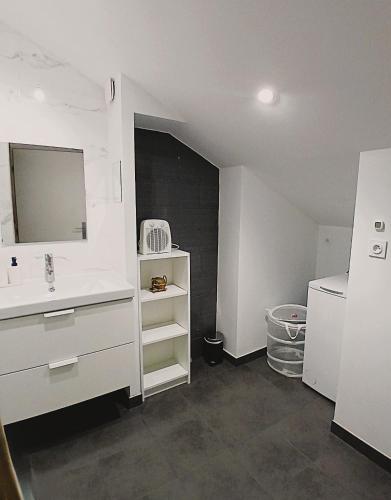 a white bathroom with a sink and a mirror at T4 en duplex, résidence atypique en pleine forêt in Yzeron