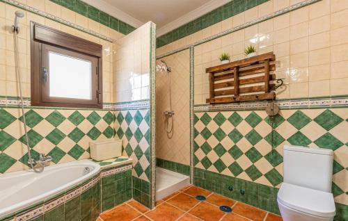 a bathroom with a tub and a toilet and a sink at Villa el Cortijo in Torrox
