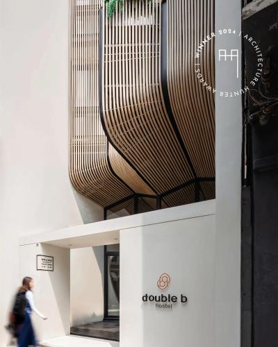 a woman walks past a display at a museum at Double B Hostel in Bangkok