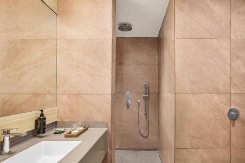 a bathroom with a shower and a sink at The Fern Residency, Solapur, Series by Marriott in Solapur
