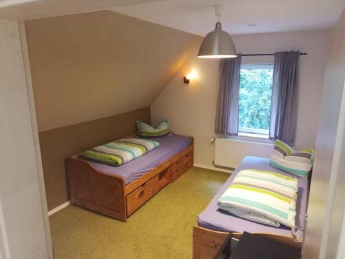 Großes Haus bei Rostock Lüsewitzer Krug bis 10 Personen في Klein Lüsewitz: غرفة صغيرة بها سريرين ونافذة