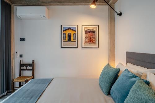 a bedroom with a bed and two pictures on the wall at The Warehouse - Industrial Loft in Faro