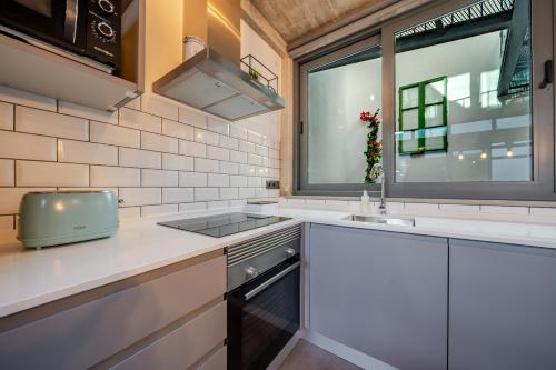 a kitchen with a sink and a window at The Warehouse - Industrial Loft in Faro