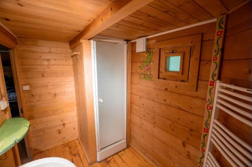 Un baño con inodoro en una habitación de madera. en Domaine de Dienné - Villages Vacances, en Dienné