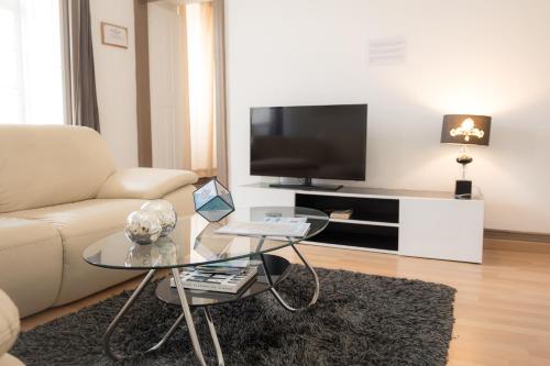 a living room with a couch and a table at Afternoon Desire in Ponta Delgada
