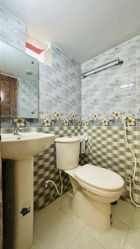 a bathroom with a toilet and a sink at Hotel Prime City Residential in Dhaka