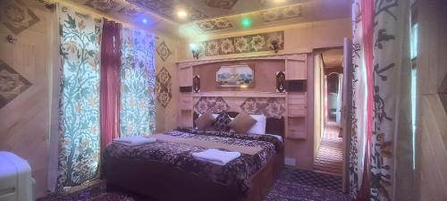 a bedroom with a bed in a room with curtains at Houseboat Quebec in Srinagar