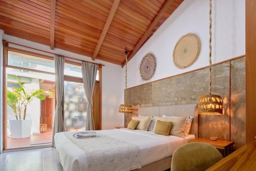 a bedroom with a large bed and a large window at Blu Galapagos Sustainable Waterfront Lodge in Puerto Ayora