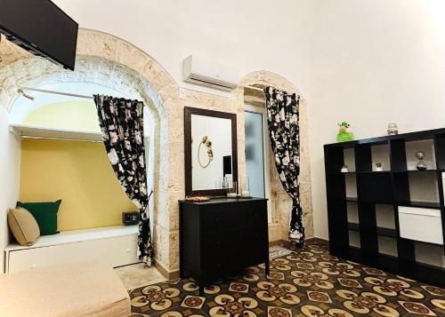 a bedroom with a mirror and a dresser in a room at Gasparro House in Turi