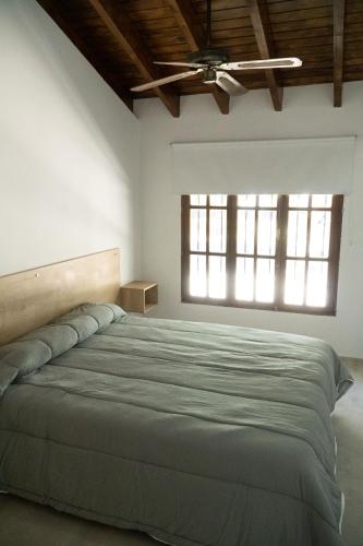 a bedroom with a large bed and a window at Grin Apartments in San Rafael