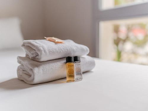 En eller flere senge i et værelse på Séjours & Affaires Nantes La Beaujoire