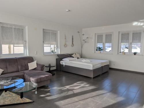 Landhaus Hotel Müller في Ringheim: غرفة معيشة بها سرير وأريكة