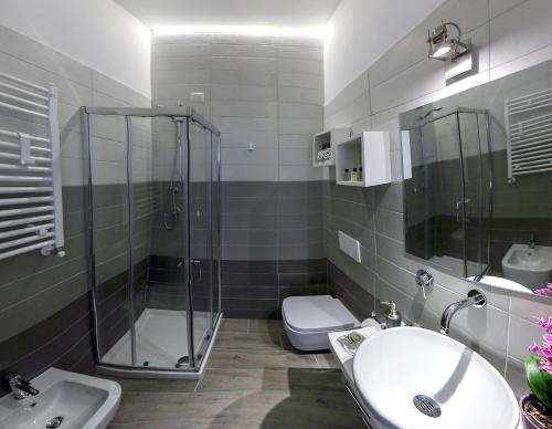 a bathroom with a shower and a sink and a toilet at Antinori Vatican Suite in Rome